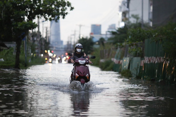 A motorcyclist drives through the flood in Ho Chi Minh City, Vietnam, October 21, 2021. Photo: Le Phan / Tuoi Tre