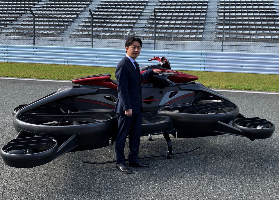 Japanese startup A.L.I. Technologies' Chief Executive Daisuke Katano poses next to its 'XTurismo Limited Edition' hoverbike during its demonstration at Fuji Speedway in Oyama, Shizuoka Prefecture, Japan, October 26, 2021. Photo: Reuters