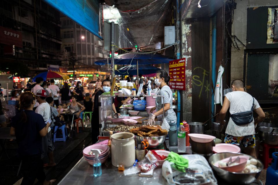 Jirintat, and Adulwitch Tangsupmanee, 42, son and daughter of Chanchai Tangsupmanee, who died at age 73 of the coronavirus disease (COVID-19) in July, during Thailand's worst wave of infections, works at their late father's food stall in Bangkok's Chinatown, Thailand, October 6, 2021. Photo: Reuters