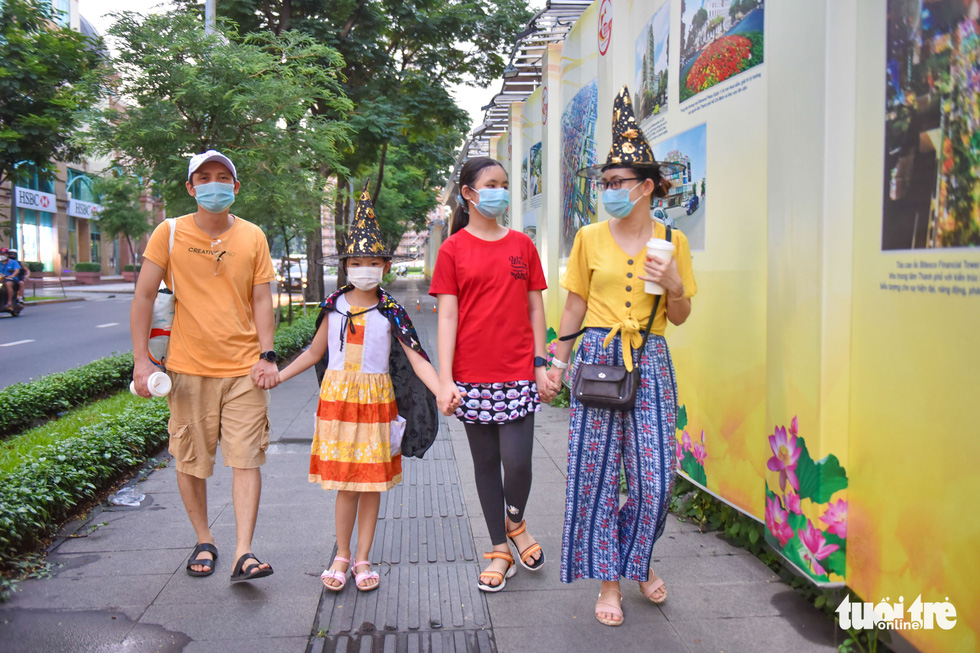 Bao Chung (right) and her family members go for a walk in Halloween costumes in District 1, Ho Chi Minh City, October 31, 2021. Photo: Ngoc Phuong / Tuoi Tre