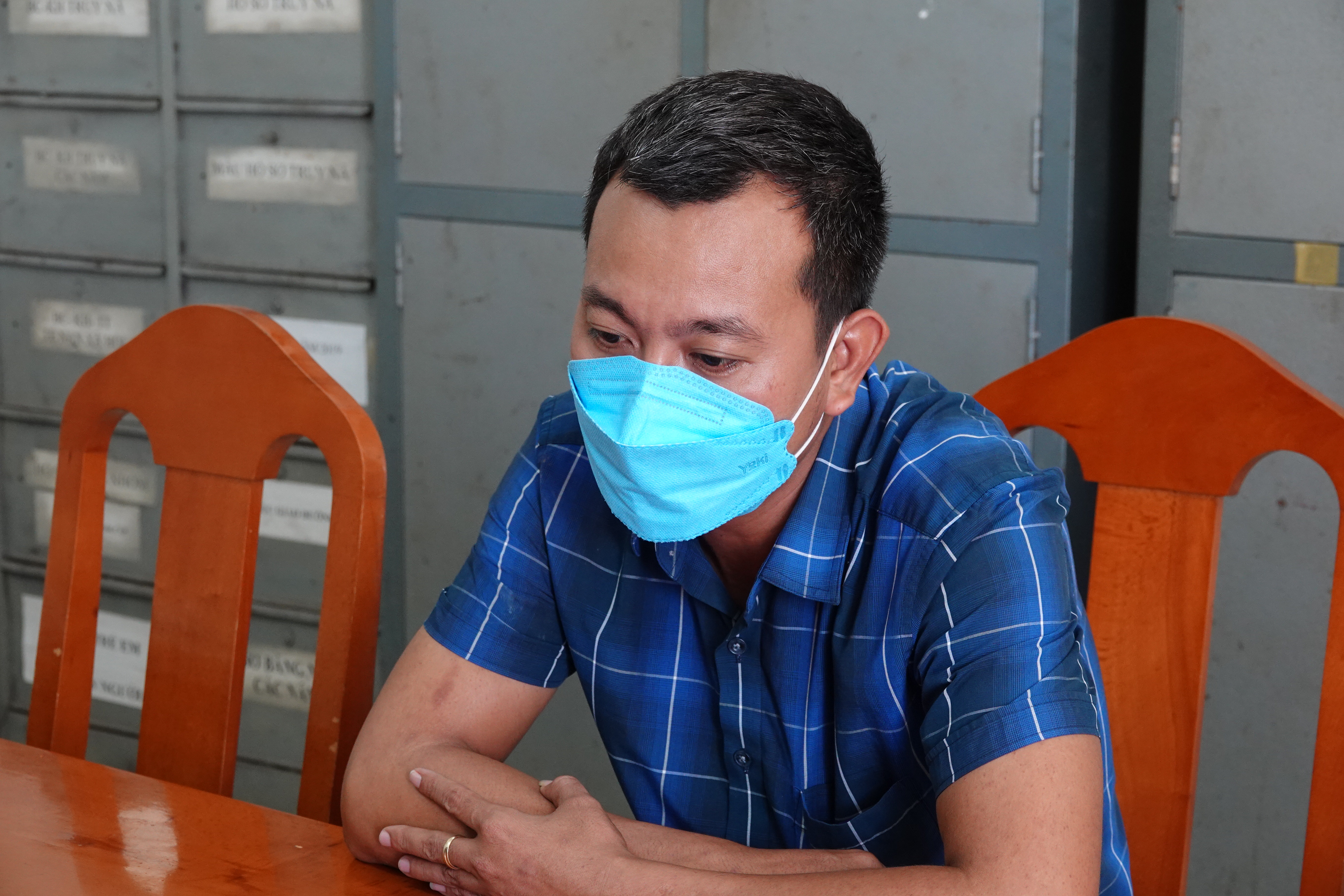 Le Anh Tuan is held at the police station in Binh Thuan Province, Vietnam. Photo: Tuan Tu / Tuoi Tre