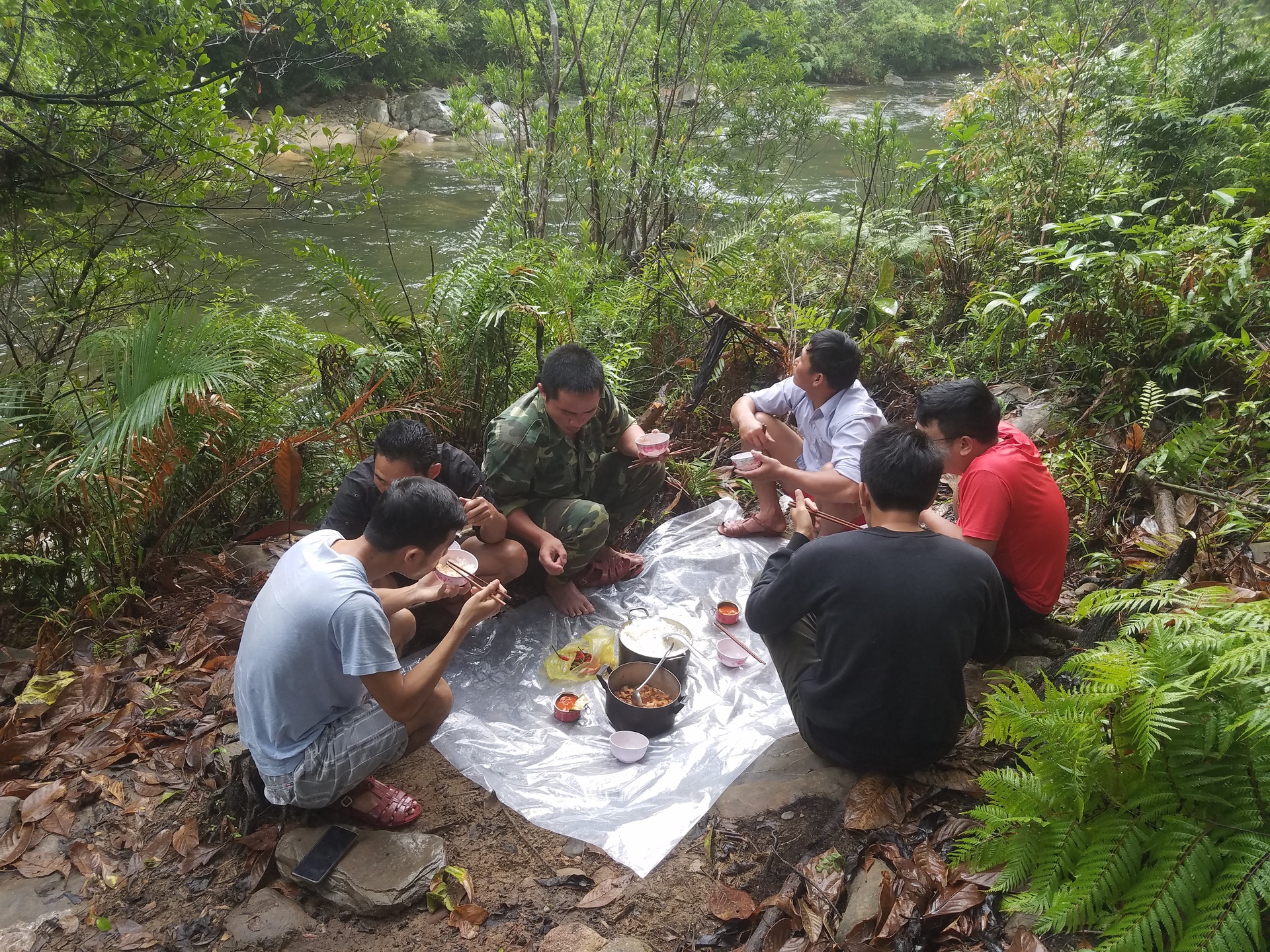 The park rangers charged with setting the camera traps at the Phong Dien Animal Sanctuary relax with a simple lunch in the middle of nature.