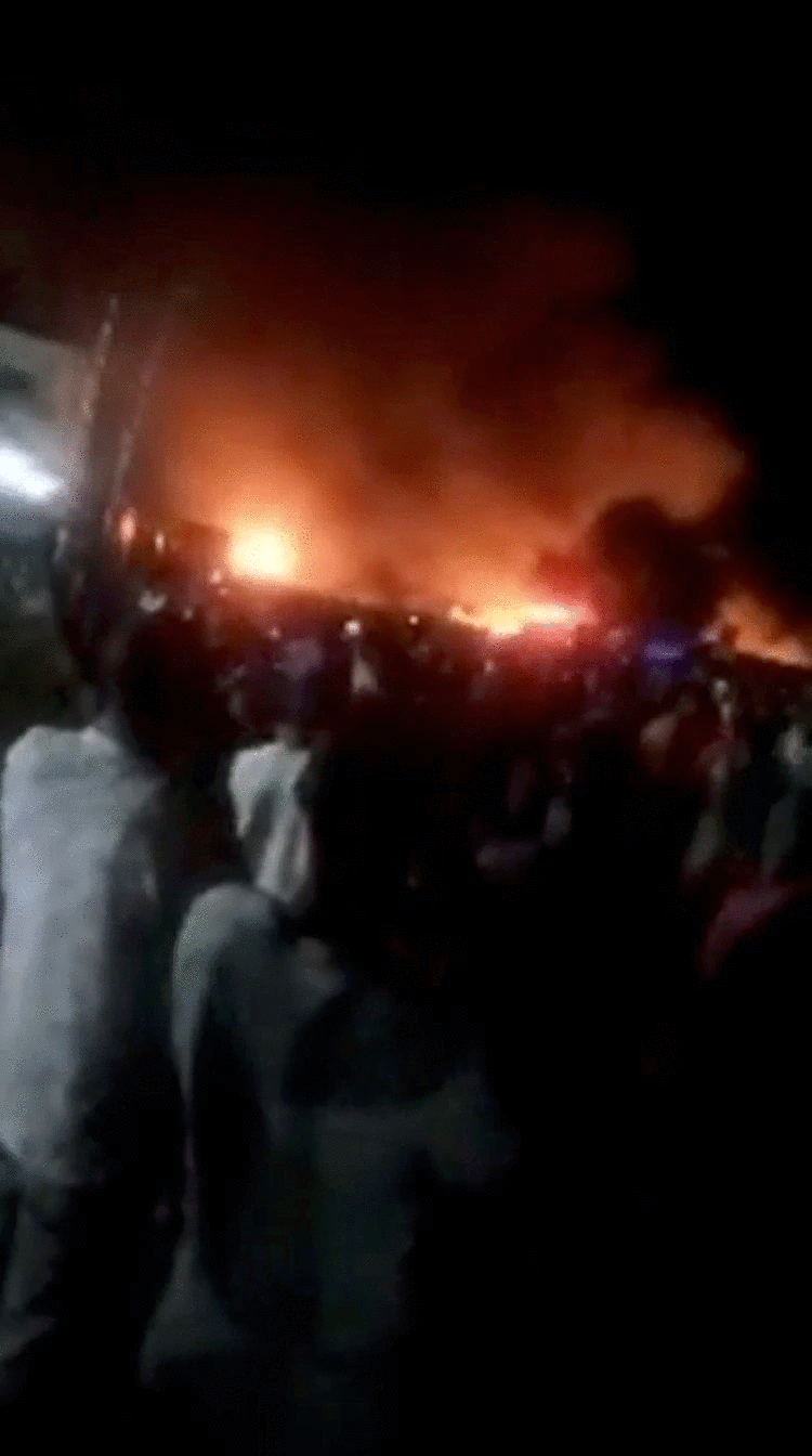 People look at fire blaze following a fuel tanker explosion in Freetown, Sierra Leone November 5, 2021 in this still image obtained from a social media video on November 6, 2021. Photo: Facebook @FODAY.KONDEH.5/via Reuters