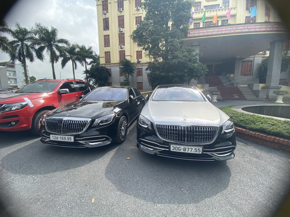 Three of the four luxury cars seized by Hanoi police from the online gambling ring are seen in this supplied photo.