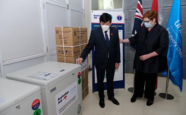 Vietnamese Minister of Health Nguyen Thanh Long (L) and Australian Minister for Foreign Affairs Marise Payne stand next to the vaccine refrigerators at the National Institute of Hygiene and Epidemiology in Hanoi, November 9, 2021 in this supplied photo.