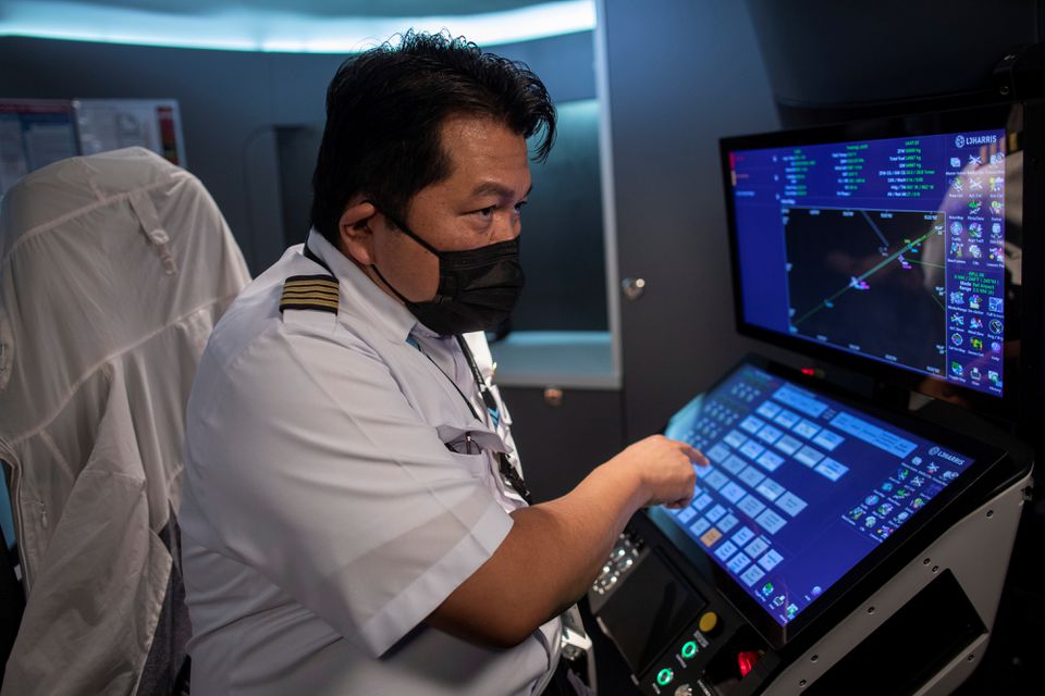 Chief Flight Instructor Frank Desiderio, wearing a mask for protection against the coronavirus disease (COVID-19), operates a flight simulator at the Alpha Aviation Group campus in Clark, Pampanga province, Philippines, November 3, 2021. Photo: Reuters