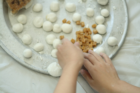 This photo shows how the visually impaired use their hands as a powerful weapon in kneading the dough into floating rice balls, which have the Vietnamese name banh troi nuoc. Photo: Vinh Ha / Tuoi Tre