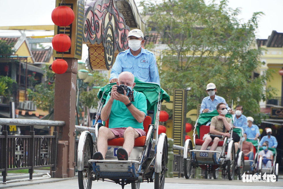 Foreign tourists travel Hoi An City in Vietnam’s central Quang Nam Province on cyclos as part of a pilot program to welcome international visitors to the locality after a two-year halt due to COVID-19 on November 20, 2021. Photo: Le Trung / Tuoi Tre