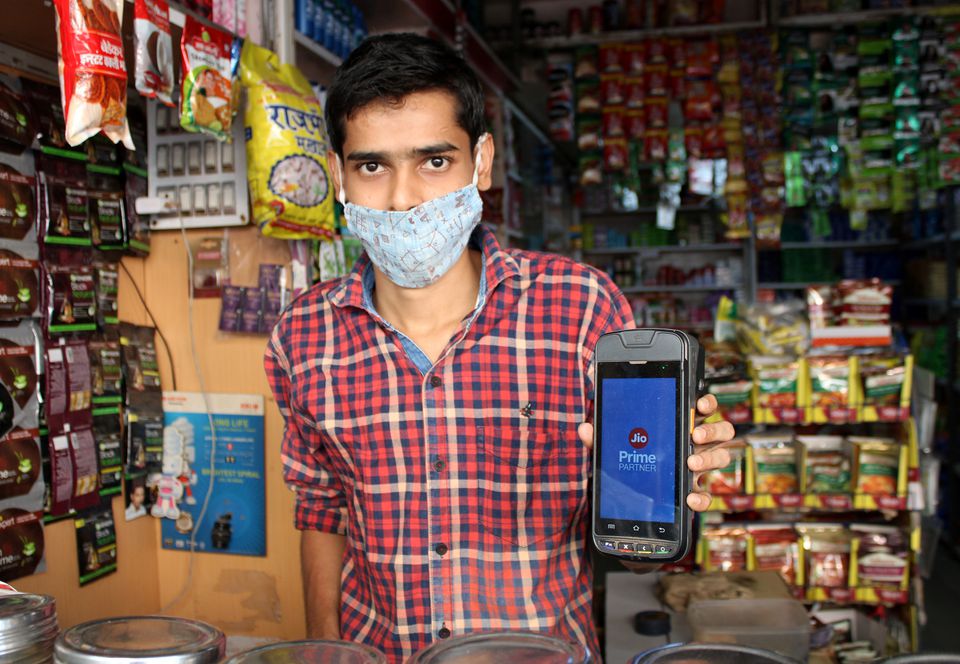 A shopkeeper selling consumer goods displays Reliance's JioMart point-of-sale machine that he uses to order supplies for his store in Sangli, in the western state of Maharashtra, India, October 21, 2021. Photo: Reuters