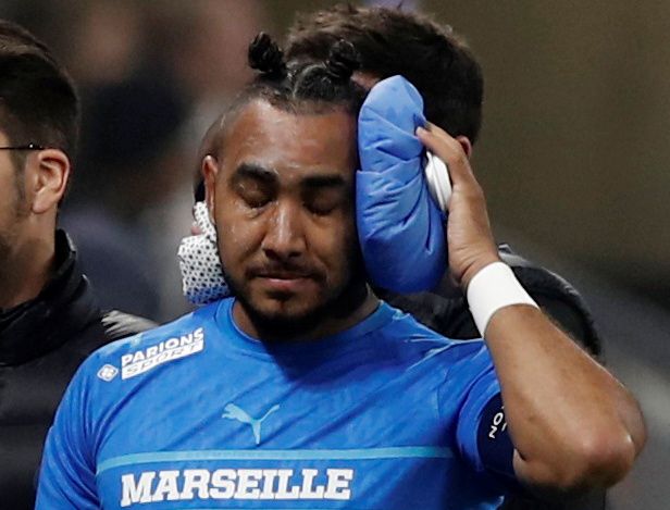 Soccer Football - Ligue 1 - Olympique Lyonnais v Olympique de Marseille - Groupama Stadium, Lyon, France - November 21, 2021 Olympique de Marseille's Dimitri Payet walks off the pitch injured after being hit by a water bottle thrown by a fan leading to the game being interrupted. Photo: Reuters