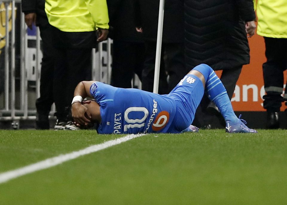 Soccer Football - Ligue 1 - Olympique Lyonnais v Olympique de Marseille - Groupama Stadium, Lyon, France - November 21, 2021 Olympique de Marseille's Dimitri Payet goes down after being hit by a water bottle thrown by a fan leading to the game being interrupted. Photo: Reuters