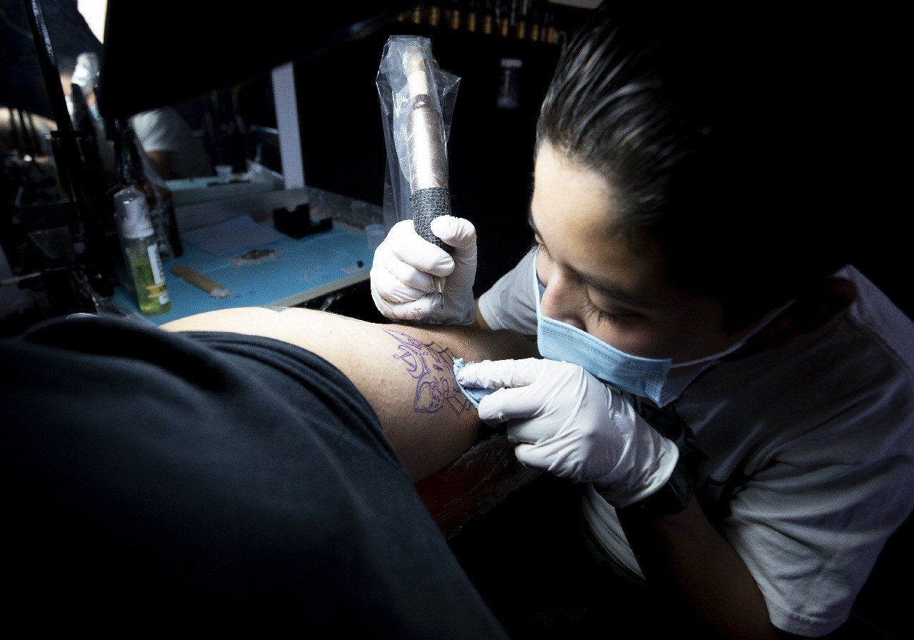 Mexican schoolboy Brandon Burgos uses a tattoo machine in the city of Puebla. Photo: AFP