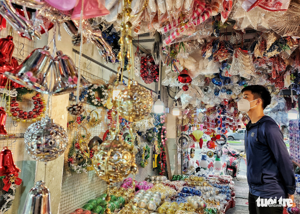 A man buys Christmas ornaments at a shop on Hai Thuong Lan Ong Street in District 5, Ho Chi Minh City. Photo: Cong Trieu / Tuoi Tre