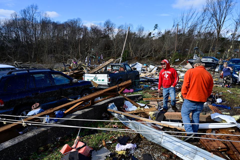 People survey the damage of the home of their grandmother, who was torn from the house and found in the street, after devastating tornadoes ripped through several U.S. states, in Dawson Springs, Kentucky, U.S., December 11, 2021. Photo: Reuters