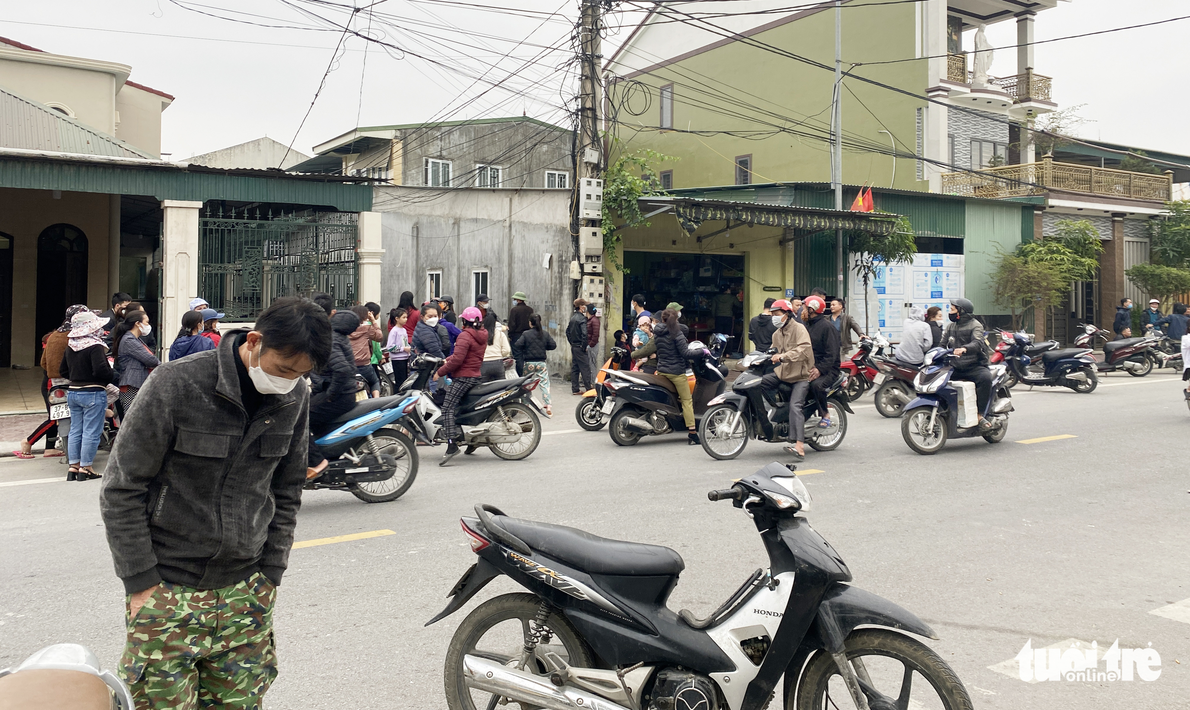 Onlookers gather at the scene of a house explosion allegedly caused by homemade firecrackers in Vinh City, Nghe An Province, Vietnam, December 13, 2021. Photo: Doan Hoa / Tuoi Tre