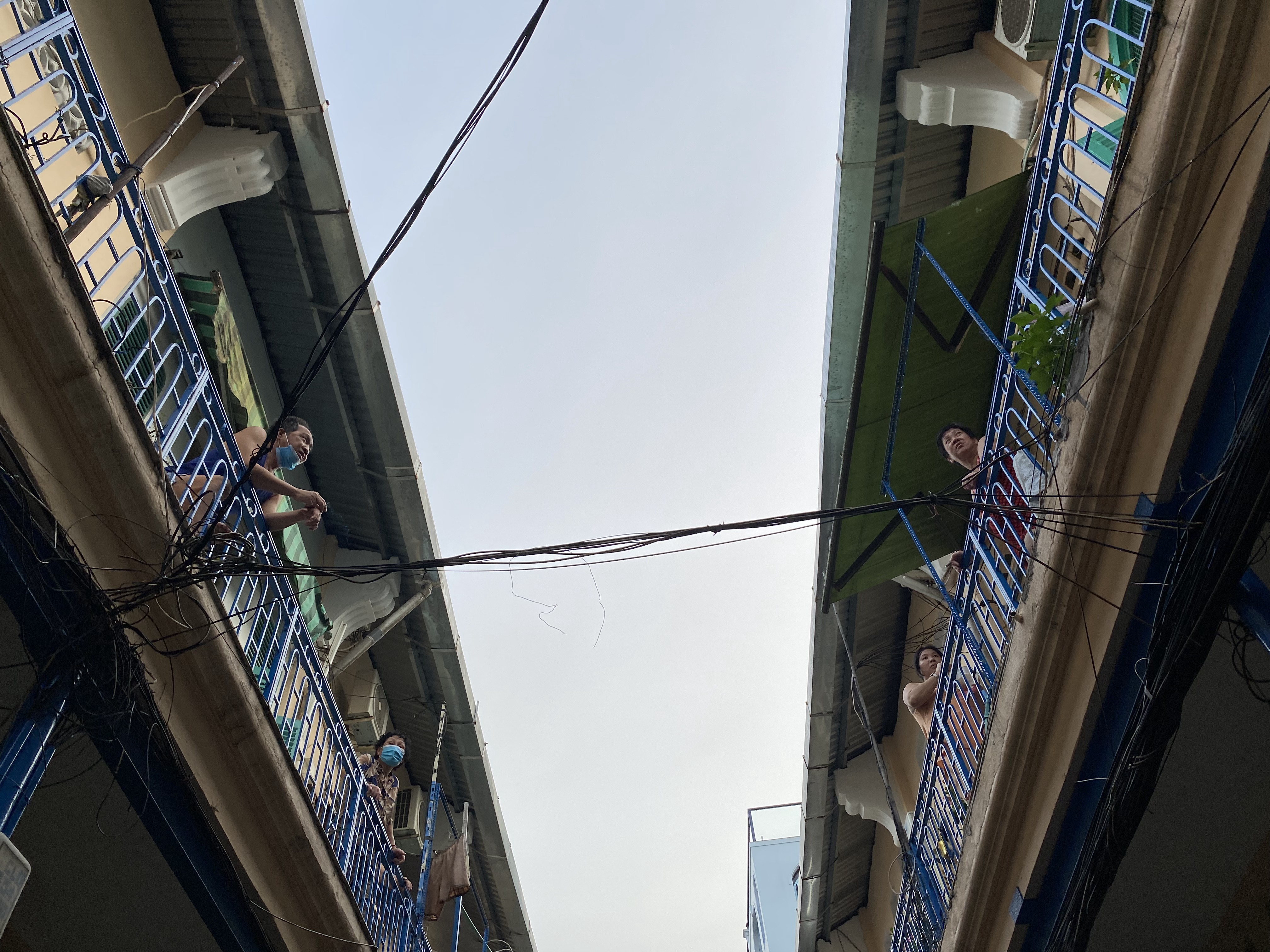 Residents of the Hao Sy Phuong residential area in Ho Chi Minh City chat on the building’s balcony. This apartment block is over 111 years old. Photo: Le Van / Tuoi Tre