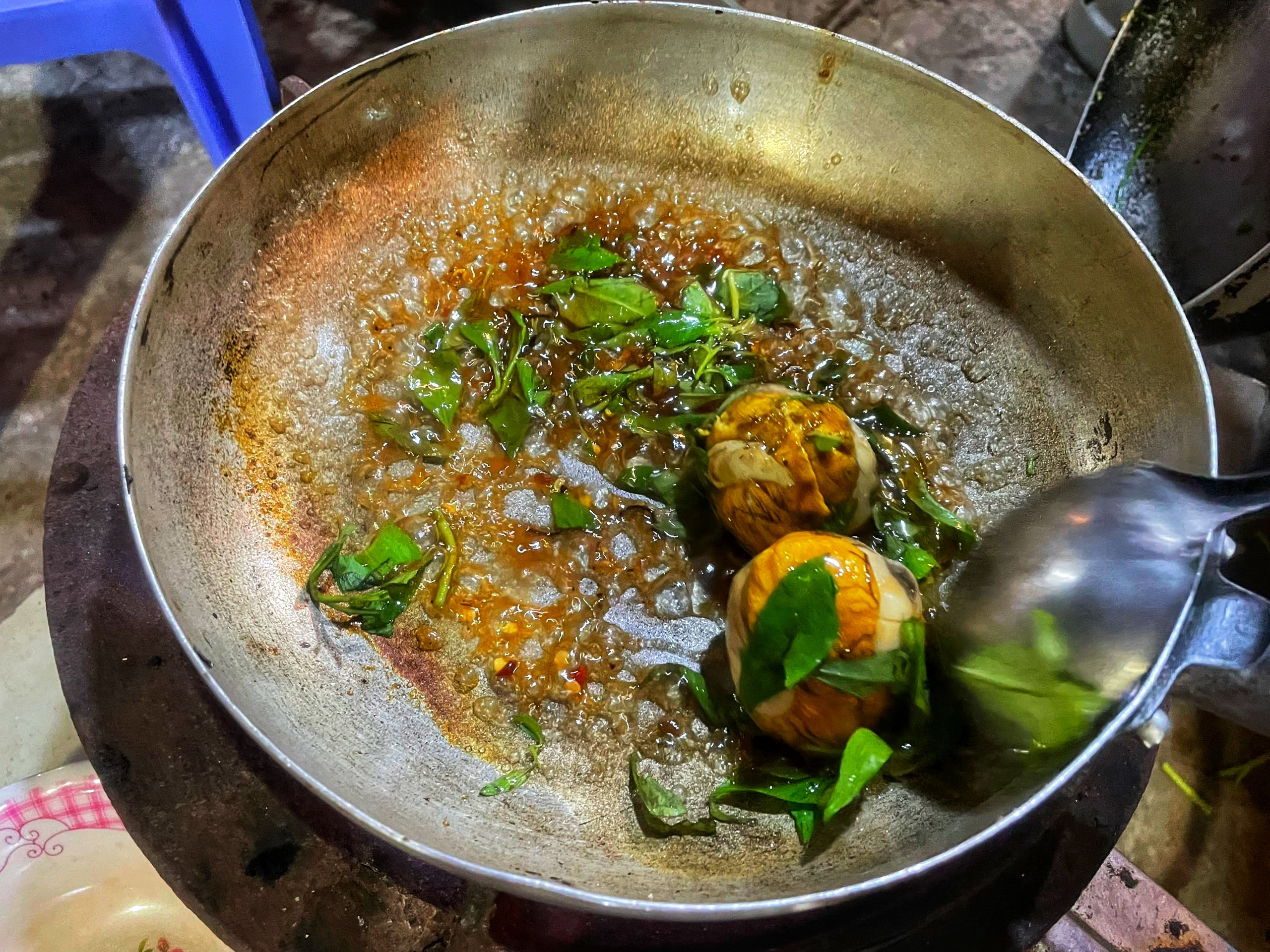 'The solid oval eggs are dropped into a pan and heated in a mixture of the sauce and some spices'. Photo: Hoang An / Tuoi Tre News