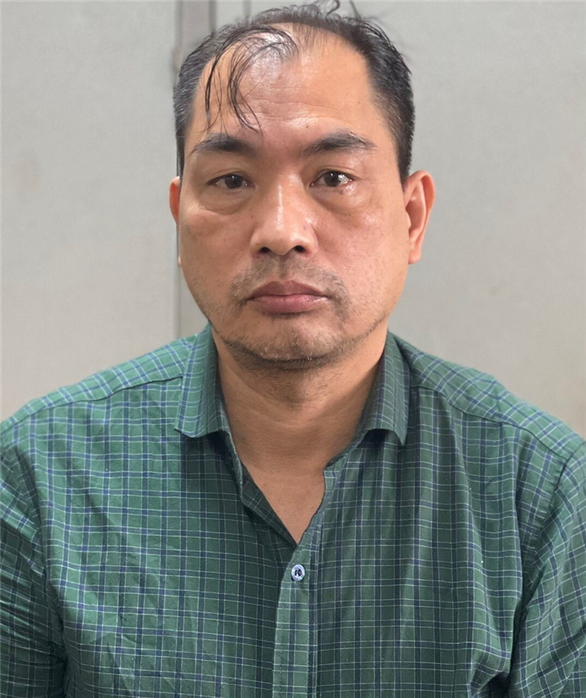 This supplied photo displays Pham Duy Tuyen, director of the Hai Duong Province Center for Disease Control, in police custody in Vietnam.