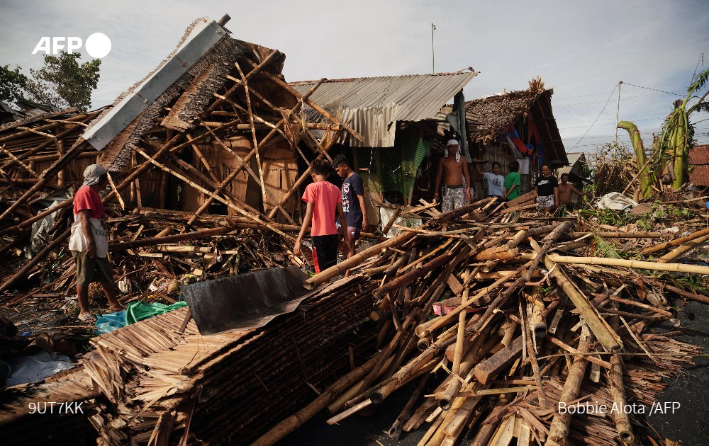 Residents salvage belongings from their destroyed homes in the coastal town of Dulag in Leyte province on December 17, 2021, a day after Super Typhoon Rai hit. Photo: AFP
