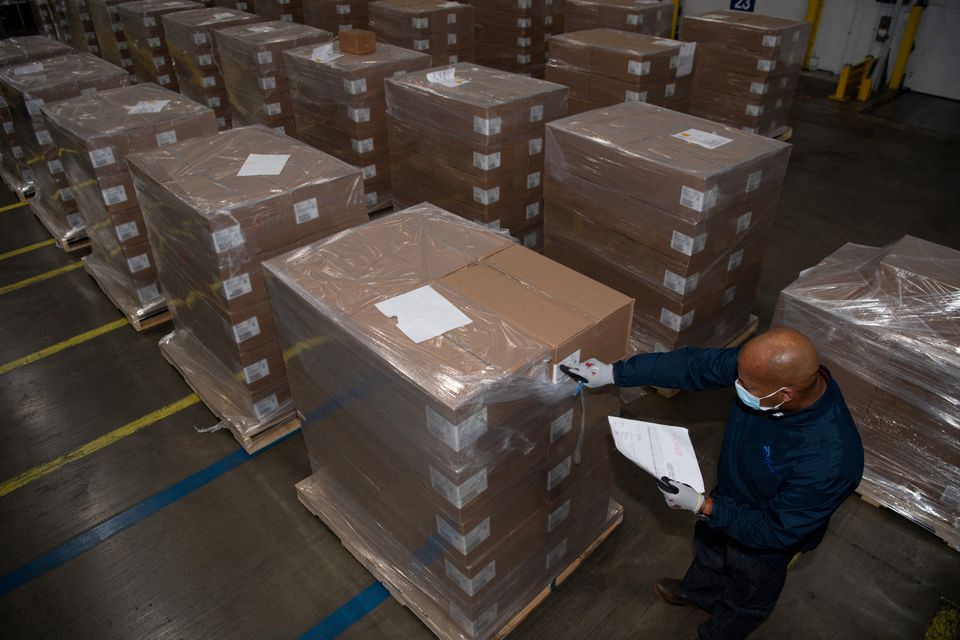 A Pfizer employee checks the boxes containing Paxlovid, COVID-19 treatment pills, at a distribution facility in Memphis, Tennessee, U.S. in this undated handout picture. Photo: Pfizer/Handout via Reuters
