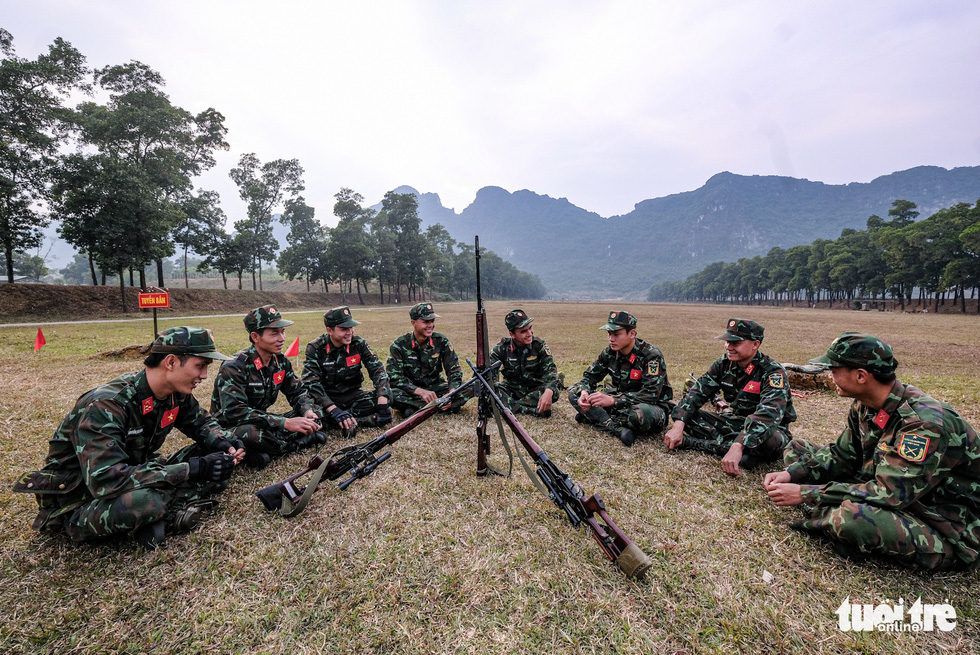 Soldiers relax after a day of training at the National Military Training Center 4 in My Duc District, Hanoi, Vietnam. Photo: Nam Tran / Tuoi Tre