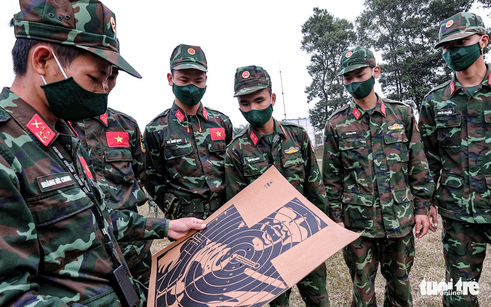 Trainer Hoang Duc Chung (left) trains recruits at the National Military Training Center 4 in My Duc District, Hanoi, Vietnam. Photo: Nam Tran / Tuoi Tre
