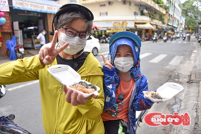 Ngoc Chau (left) and her son buy Ka Lo Chia from Khuu Thi Tu Anh’s stall in Luong Nhu Hoc Street, District 5, Ho Chi Minh City. Photo: Ngoc Phuong / Tuoi Tre