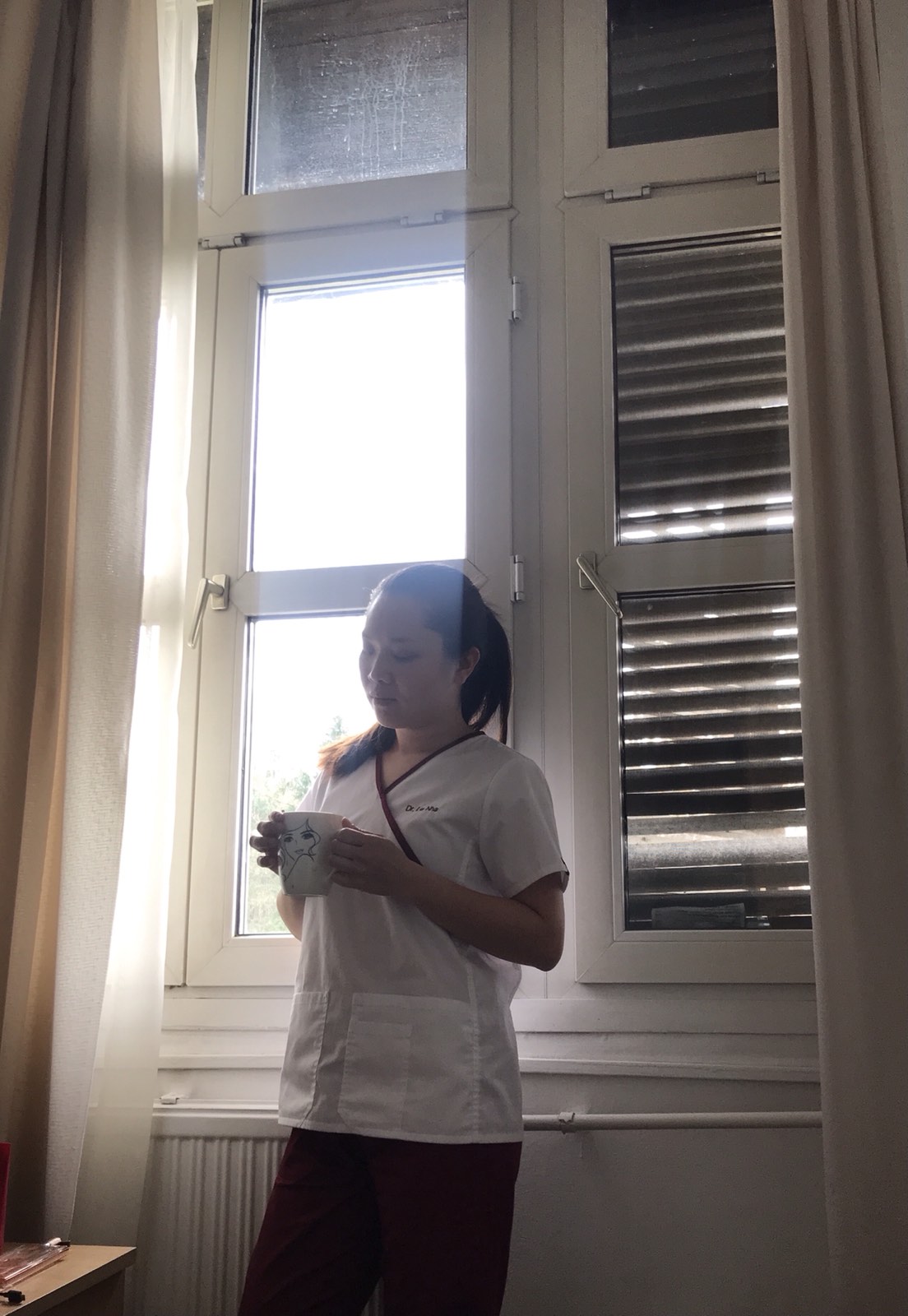 Doctor Hoa Nha on the morning she got the news of her father-in-law’s death. One of her coworkers took the photo without knowing her intense emotion that morning. Photo supplied.