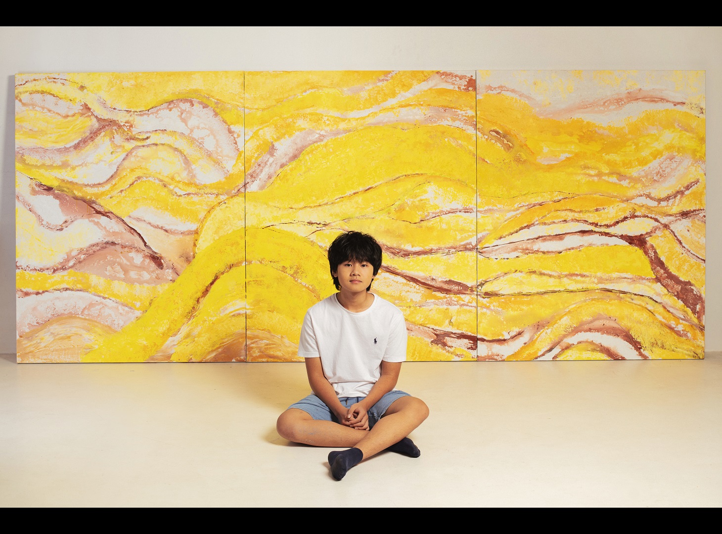 A supplied photo of 14-year-old Vietnamese art prodigy Xeo Chu and his works featuring the Mu Cang Chai terraced rice fields from the northern mountainous province of Yen Bai.