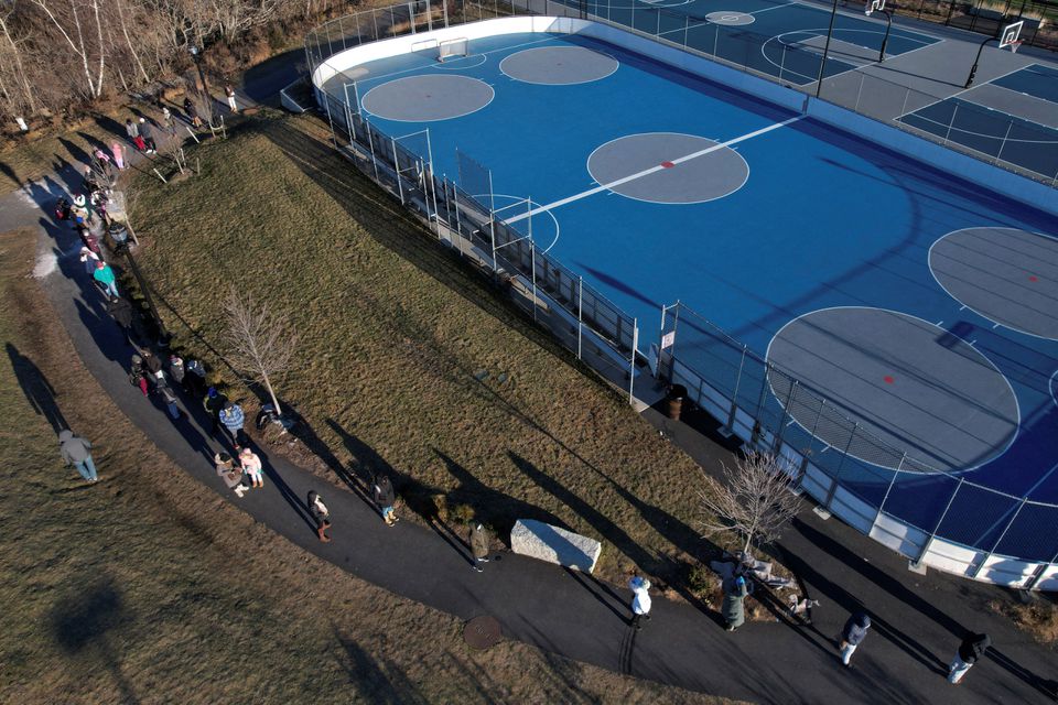 People line up in cold winter temperatures to be tested for the coronavirus disease (COVID-19) in Everett, Massachusetts, U.S., January 4, 2022. Picture taken with a drone. Photo: Reuters