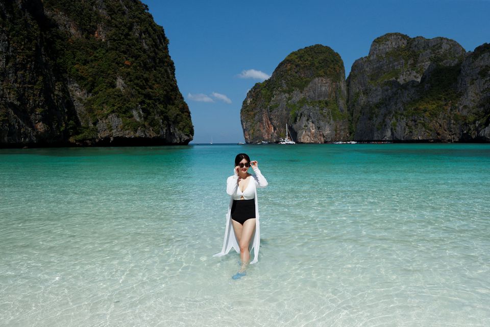 A tourist poses at Maya Bay as Thailand reopens its world-famous beach after closing it for more than three years to allow its ecosystem to recover from the impact of overtourism, at Krabi province, Thailand, January 3, 2022. Photo: Reuters