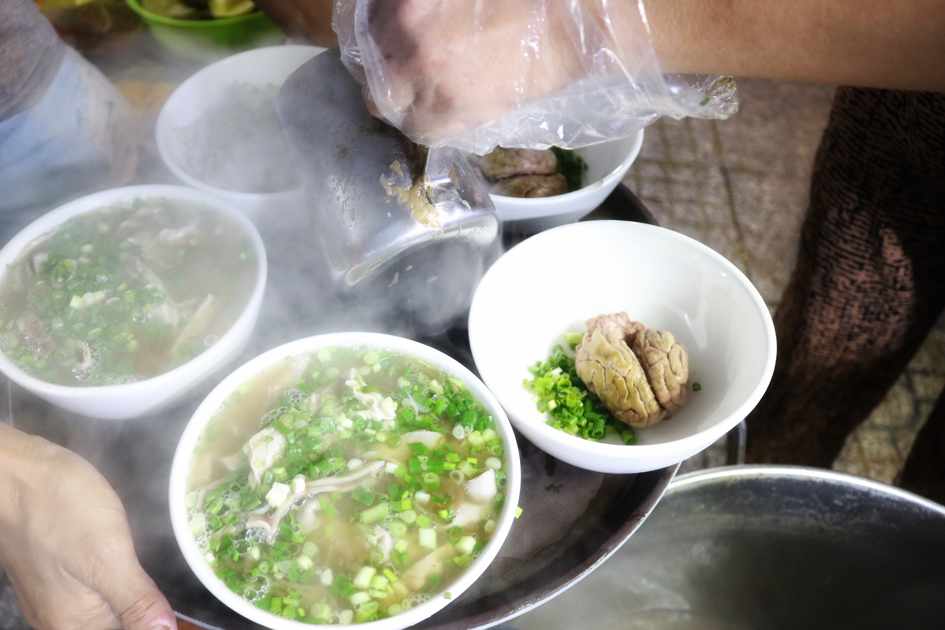 Besides pig organs, customers can add pig brains to their bowl of steamed blood pudding at Pham Thi Hoa’s stall on Pham Van Hai Street in Tan Binh District, Ho Chi Minh City. Photo: Hoang An / Tuoi Tre News