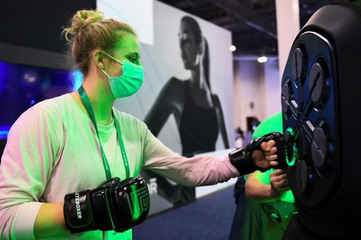 An attendee uses a Liteboxer interactive boxing home workout during the Consumer Electronics Show (CES) on January 7, 2022 in Las Vegas, Nevada. Photo: AFP