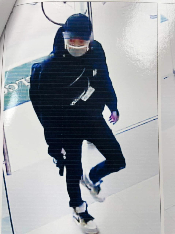 The robbery suspect is shown entering the Dinh Vu branch of Vietcombank in Hai Phong City, Vietnam with a gun in his hand in this image, which was extracted from the branch’s security camera, on January 7, 2022.
