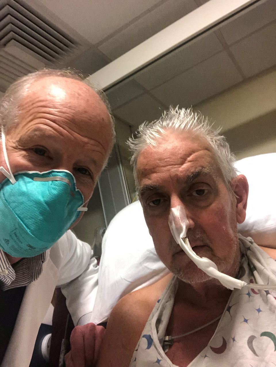 David Bennett, a 57-year-old patient with terminal heart disease, poses with surgeon Bartley P. Griffith, MD before he received a successful transplant of a genetically-modified pig heart at University of Maryland Medical Center in Baltimore, Maryland, U.S. in an undated photograph. University of Maryland School of Medicine (UMSOM)/Handout via Reuters