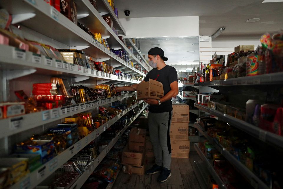 A seller arranges products at his shop during a blackout, amid a heat wave, in Buenos Aires, Argentina January 11, 2022. Photo: Reuters