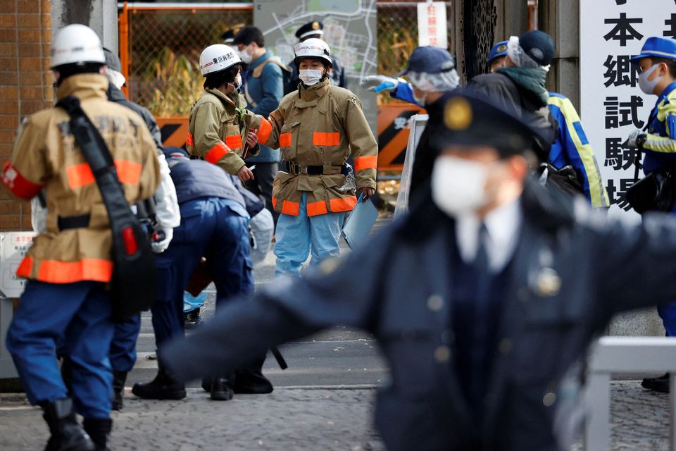 Emergency personnel are seen at the site where a stabbing incident happened at an entrance gate of Tokyo University in Tokyo, Japan January 15, 2022. Photo: Reuters