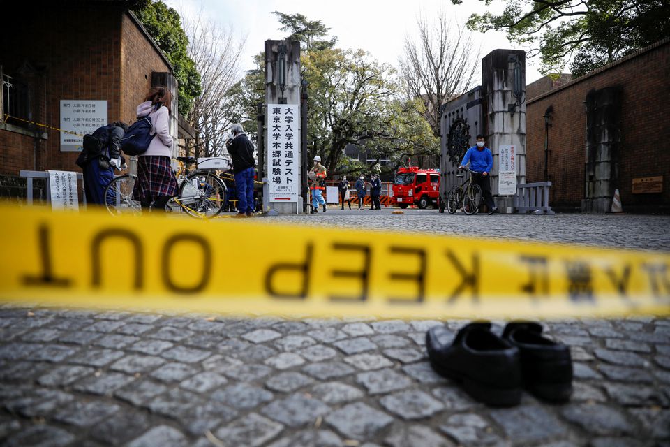 Police officers inspect at the site where a stabbing incident happened at an entrance gate of Tokyo University in Tokyo, Japan January 15, 2022. Photo: Reuters