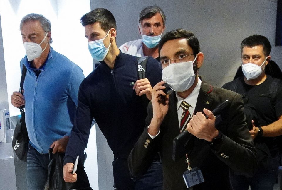 Serbian tennis player Novak Djokovic walks with his team after landing at Dubai Airport after the Australian Federal Court upheld a government decision to cancel his visa to play in the Australian Open, in Dubai, United Arab Emirates, January 17, 2022. Photo: Reuters