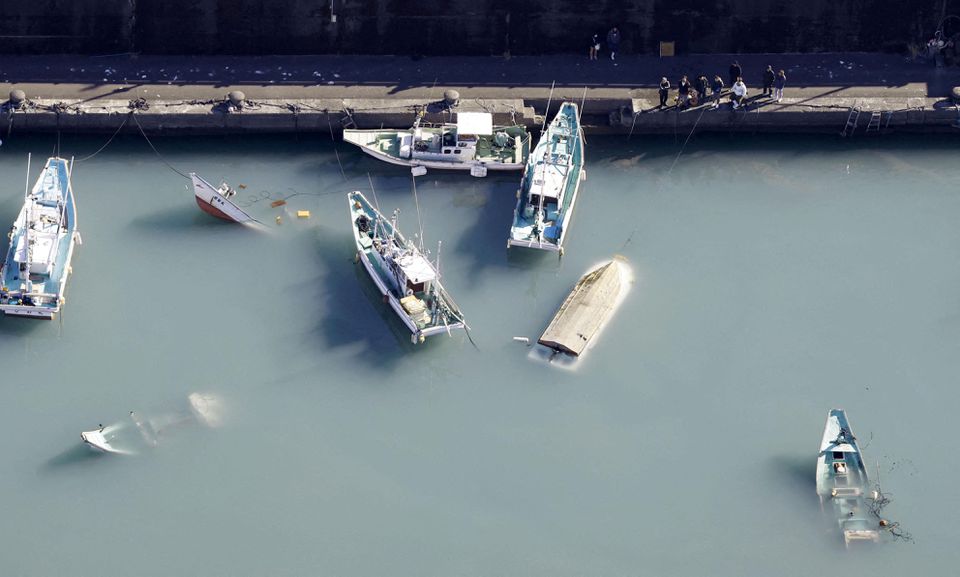 An aerial view shows capsized boats believed to be affected by the tsunami caused by an underwater volcano eruption on the island of Tonga at the South Pacific, in Muroto, Kochi prefecture, Japan, in this photo taken by Kyodo January 16, 2022. Photo: Kyodo/via REUTERS