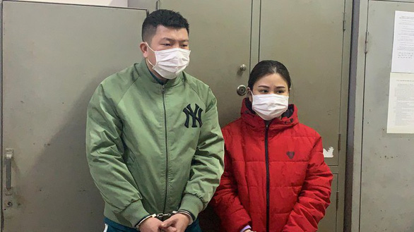 Vu Kim Hoa (right) and ex-prisoner Nguyen Dang Ninh are seen at the police station for allegedly running an illicit arms trade in northern Vietnam.