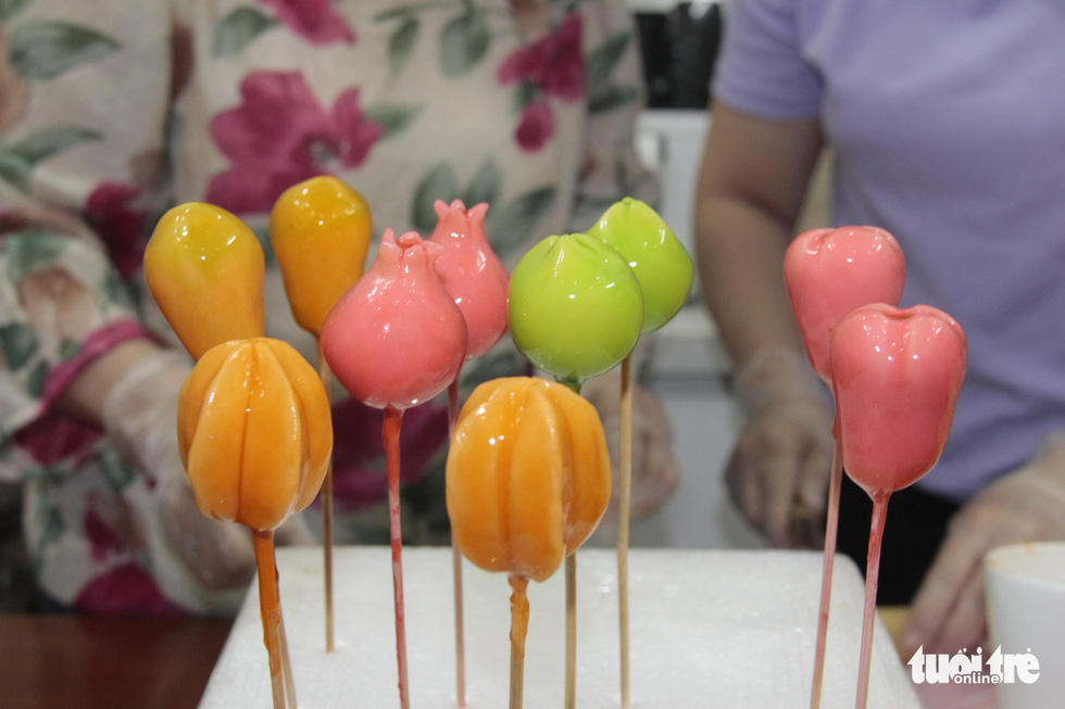 The 'fruits' are left to dry after being colored and coated with jelly. Photo: Cong Trieu / Tuoi Tre