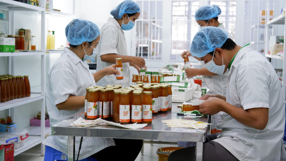 Sokfarm’s employees are seen working in a lab producing the syrup in a supplied photo.