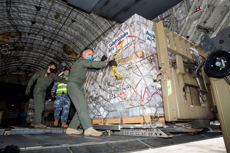 Australian Defence Forces members unload humanitarian assistance and engineering equipment from an aircraft at Fua'amotu International Airport, Tonga, January 20, 2022. Photo: Australian Department Of Defence/Handout via REUTERS