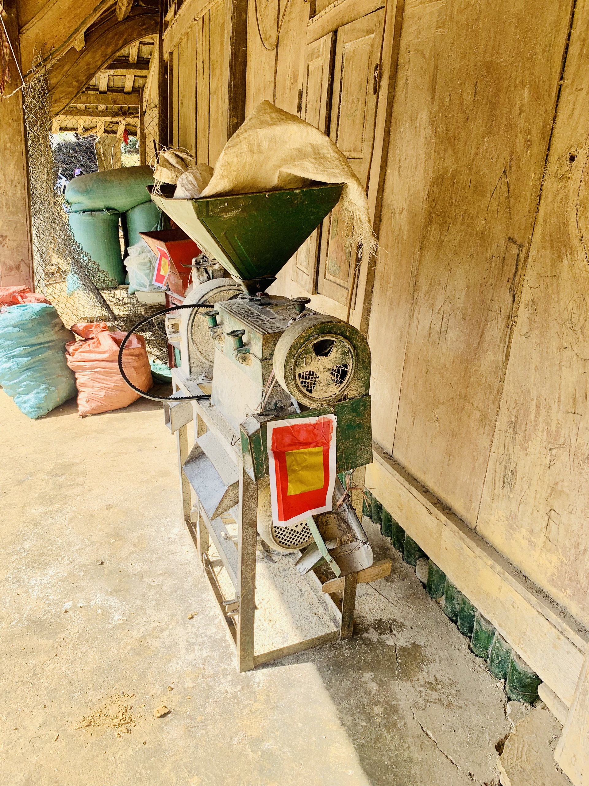 The Mong people stick good luck tokens on animals and objects around the house, including this rice processing machine, to thank them for a year of hard work. Photo: Duc Anh / Tuoi Tre