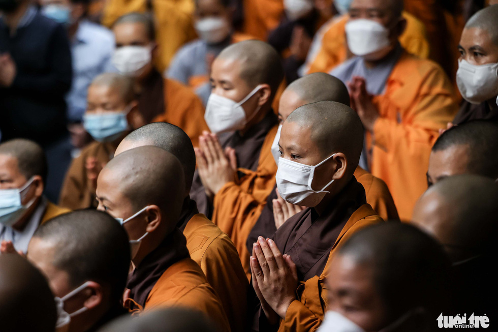 Buddhists are seen attending the shrouding ceremony on the first day of the seven-day funeral in silence of the late Venerable Thich Nhat Hanh at Tu Hieu Temple in Hue City, Vietnam on January 23, 2021. Photo: Nguyen Khanh / Tuoi Tre