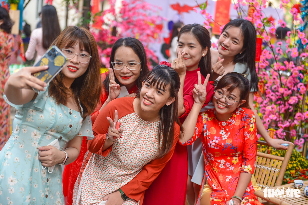 Young ladies taking selfies in their Ao Dai, the Vietnamese traditional dress.