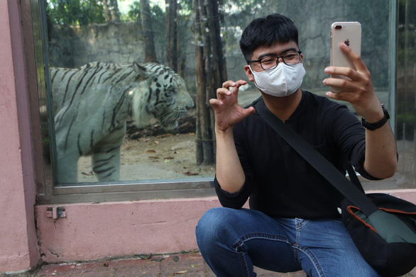 Young people pose with zodiac animal to pray for good luck in Vietnam