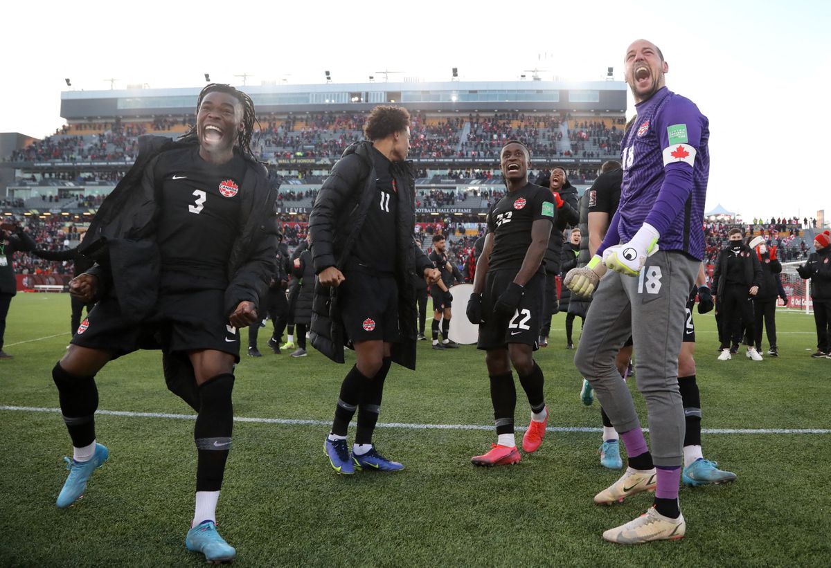 Soccer Football - World Cup - CONCACAF Qualifiers - Canada v United States - Tim Hortons Stadium, Hamilton, Canada - January 30, 2022 Canada's Sam Adekugbe and Milan Borjan celebrate after the match. Photo: Reuters