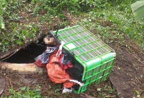The body of P.T.T. is found in the biogas pit behind Nguyen Thi Vuong’s house in Thanh Hoa Province in this photo supplied by a local resident.